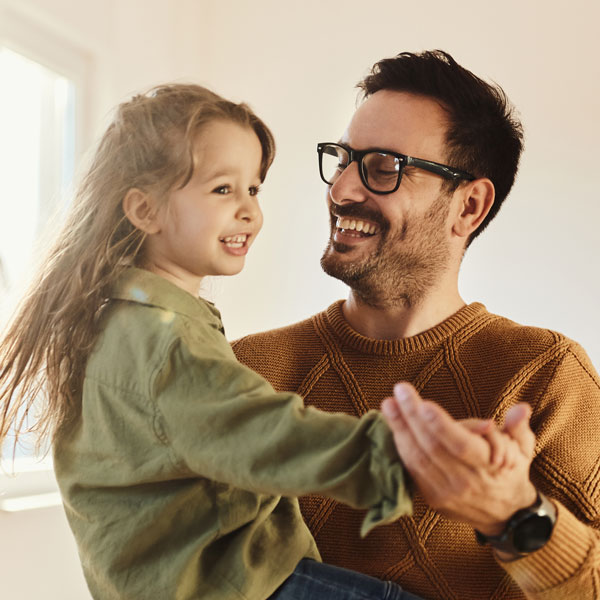 father and daughter dancing and smiling