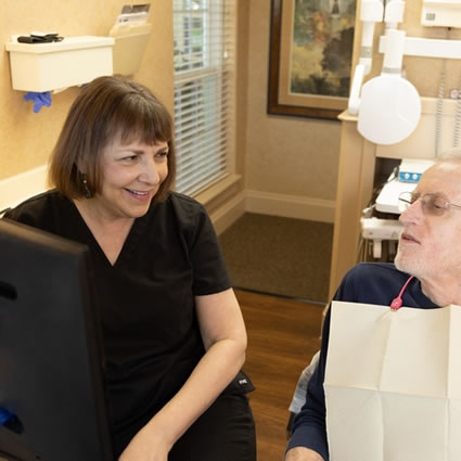 hygienist showing patient their x-ray