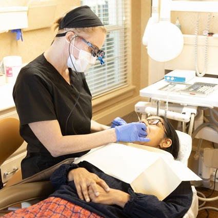 dental hygienist cleaning a patient's teeth